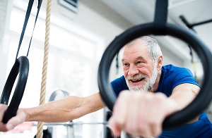 graphicstock senior man in sports clothing in gym working out on gymnastic rings close up of hands BubisA3HzW