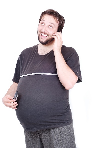 man with a big stomach is speaking on cell phone with a baby in his stomach rte uQR4j