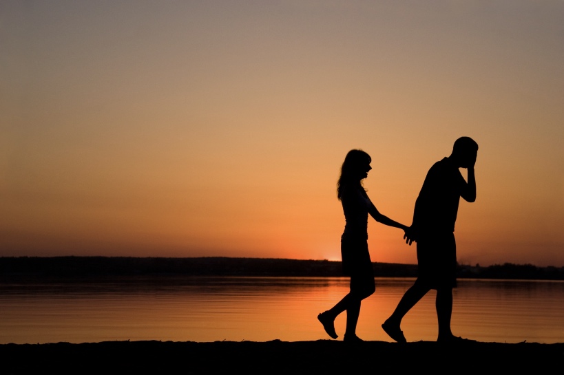 vrouw volgt man op strand